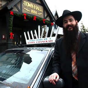 Rabbi Mendy Bukiet of Chabad of Bradenton displays a menorah on the roof of his 2003 Sonata, which will light up during Hanukkah.